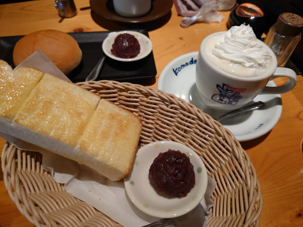 Komeda thick toast with sweet red-bean paste and a coffee topped with cream.