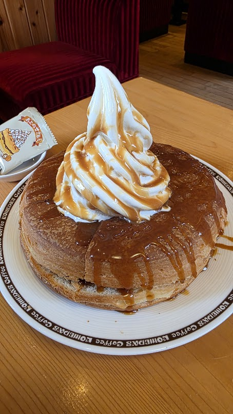 Komeda Shiro-Noir pastry topped with soft-serve ice cream and syrup.