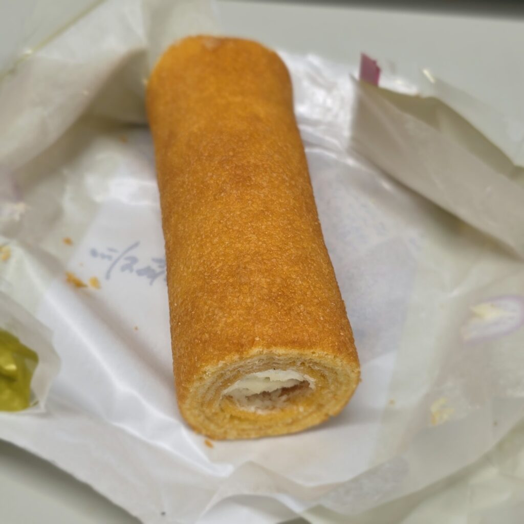 An unwrapped Nagasaki Monogatari cake, a narrow Baumkuchen filled with white cream.